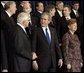 President George W. Bush speaks with Czech President Vaclav Klaus as world leaders take their place for the official NATO photo at the NATO Headquarters in Brussels Tuesday, Feb. 22, 2005. White House photo by Eric Draper