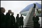 German Chancellor Gerhard Schroeder, fourth from left, and others wait on the tarmac as arriving U.S. President George W. Bush deplanes Air Force One at Rhein-Main Air Base in Frankfurt, Germany. White House photo by Eric Draper