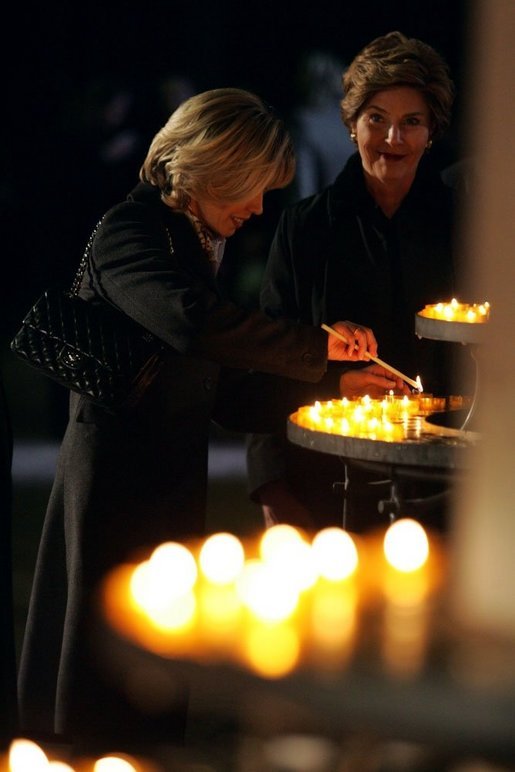 Laura Bush and Mrs. Schroeder-Koepf light candles during a tour of Saint Martin's Cathedral in Mainz, Germany, Feb. 23, 2005. White House photo by Paul Morse