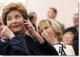 Laura Bush listens to translation headphones during a joint press conference with President George W. Bush and German Chancellor Gerhard Schroeder at the Electoral Palace in Mainz, Germany, Wednesday, Feb. 23, 2005. The Chancellor’s wife, Mrs. Schroeder-Koepf is seated next to Mrs. Bush.  White House photo by Eric Draper