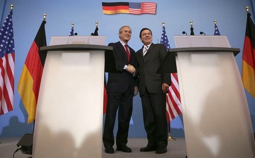 President George W. Bush shakes hands with German Chancellor Gerhard Schroeder during a Feb. 23, 2005, joint press conference at the Electoral Palace in Mainz, Germany. White House photo by Eric Draper