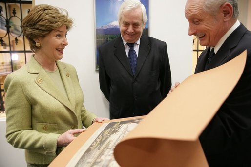 During the opening of University Library's "Info USA," Tibor Trgina, General Director of the library, shows Laura Bush books and artwork preserved at the library in Bratislava, Slovak Republic. Laura Bush was also joined by Slovak Republic's Minister of Culture Rudolf Chmel, center, during her visit to the library, Thursday, Feb. 24, 2005. White House photo by Susan Sterner