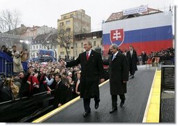 President George W. Bush gives his thumbs up as he leaves the stage with Prime Minister Mikulas Dzurinda of Slovakia after speaking at Hviezdoslavovo Square in Bratislava, Slovakia, Thursday, Feb. 24, 2005.   White House photo by Eric Draper
