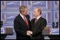 President George W. Bush and Russian President Vladimir Putin clasp hands after a joint news conference Thursday, Feb. 24, 2005, in Bratislava, Slovakia. Said President Bush, "I applaud President Putin for dealing with a country that is in transformation," adding, "It's been hard work." White House photo by Paul Morse