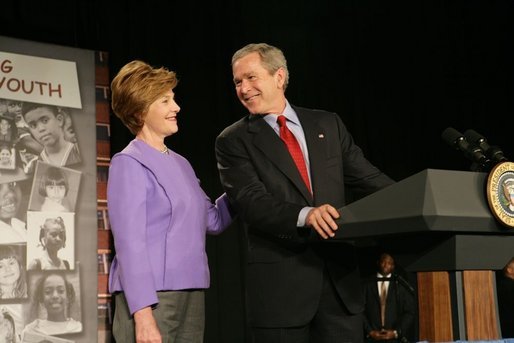 President George W. Bush and Laura Bush laugh as he introduces her during her remarks on Helping America's Youth at the Community College of Allegheny County in Pittsburgh Monday, March 7, 2005. White House photo by Susan Sterner