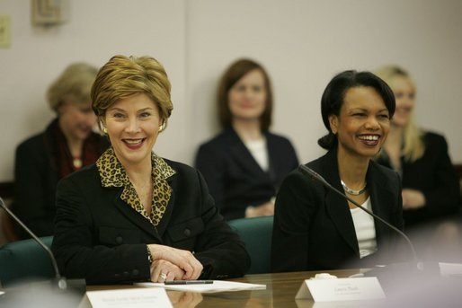 Laura Bush and Secretary of State Condoleezza Rice laugh during a roundtable discussion with women leaders from around the world held in honor of International Women's Day at the State Department in Washington, D.C. Tuesday, March 8, 2005. Today in her remarks at the State Department Mrs. Bush said, "We all have an obligation to speak for women who are denied their rights to learn, to vote or to live in freedom. We may come from different backgrounds, but advancing human rights is the responsibility of all humanity, a commitment shared by people of goodwill on every continent." White House photo by Susan Sterner