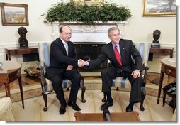 President George W. Bush welcomes Romanian President Traian Basescu to the Oval Office Wednesday, March 9, 2005. President Bush and President Basescu met to discuss regional security and diplomatic issues.  White House photo by Paul Morse