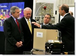 President George W. Bush looks at a prototype for a fuel cell auxiliary power unit for the Bradley A3 fighting vehicle during a tour of the technology company, "Battelle," with Energy Secretary Sam Bodman, left, vice president Bill Madia, center, and vice president Henry Cialone in Columbus, Ohio, Wednesday, March 9, 2005.  White House photo by Krisanne Johnson
