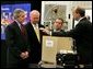 President George W. Bush looks at a prototype for a fuel cell auxiliary power unit for the Bradley A3 fighting vehicle during a tour of the technology company, "Battelle," with Energy Secretary Sam Bodman, left, vice president Bill Madia, center, and vice president Henry Cialone in Columbus, Ohio, Wednesday, March 9, 2005. White House photo by Krisanne Johnson