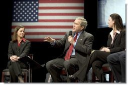 President George W. Bush discusses his proposal to reform Social Security with University of Louisville students Lindsey Mottley, left, and Rebecca Dean, right, in Louisville, Ky., Thursday, March 10, 2005.  White House photo by Paul Morse