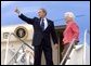 Before departing Pensacola en route Orlando, Fla., President George W. Bush gives a thumbs up sign while boarding Air Force One with his mother Barbara Bush Friday, March 18, 2005. White House photo by Eric Draper