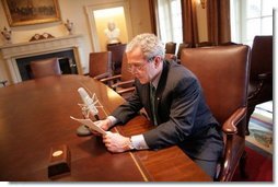 President George W. Bush records his radio address for a Saturday morning broadcast in the Cabinet Room of the White House Thursday, March 17, 2005.  White House photo by Eric Draper