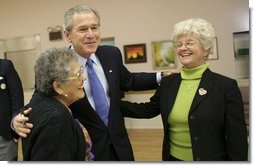 President George W. Bush greets Millie Martinez, right, and Ida Gonzalez at Bear Canyon Senior Center in Albuquerque, Tuesday, March 22, 2005, as he took his Conversation for Strengthening Social Security into New Mexico. The president reassured the approximately 30 breakfast guests that those born before 1950 will be unaffected by proposed reforms to the program.   White House photo by Eric Draper