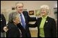 President George W. Bush greets Millie Martinez, right, and Ida Gonzalez at Bear Canyon Senior Center in Albuquerque, Tuesday, March 22, 2005, as he took his Conversation for Strengthening Social Security into New Mexico. The president reassured the approximately 30 breakfast guests that those born before 1950 will be unaffected by proposed reforms to the program. White House photo by Eric Draper