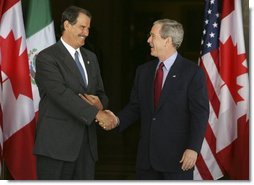 President George W. Bush greets Mexican President Vicente Fox at the beginning of meetings between the United States, Mexico and Canada at Baylor University in Waco, Texas, Wednesday, March 23, 2005.  White House photo by Krisanne Johnson