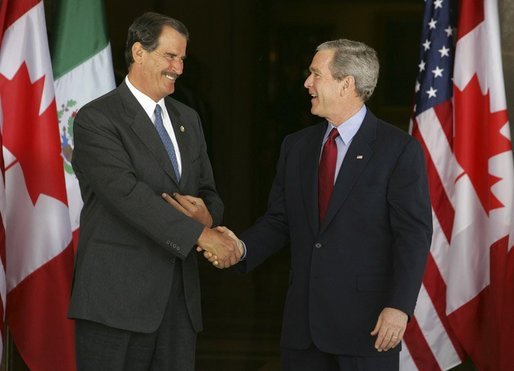 President George W. Bush greets Mexican President Vicente Fox at the beginning of meetings between the United States, Mexico and Canada at Baylor University in Waco, Texas, Wednesday, March 23, 2005. White House photo by Krisanne Johnson