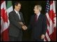 President George W. Bush greets Mexican President Vicente Fox at the beginning of meetings between the United States, Mexico and Canada at Baylor University in Waco, Texas, Wednesday, March 23, 2005. White House photo by Krisanne Johnson