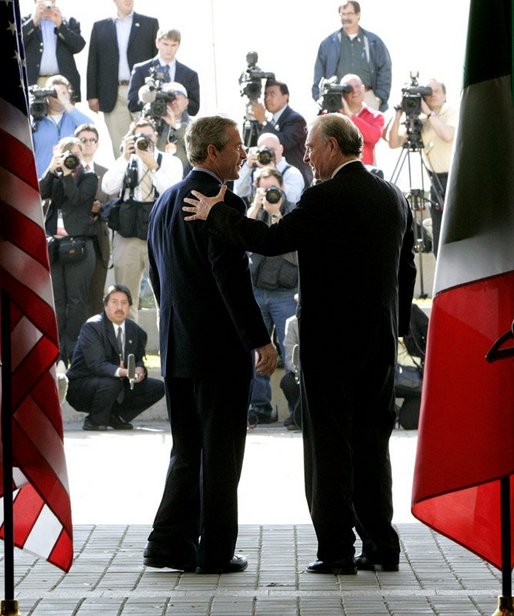 President George W. Bush greets Canadian Prime Minister Paul Martin at the beginning of meetings between the United States, Mexico and Canada at Baylor University in Waco, Texas, Wednesday, March 23, 2005. White House photo by Eric Draper