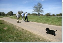 As Barney follows along, President George W. Bush walks with Canadian Prime Minister Paul Martin, left, and Mexican President Vicente Fox in Crawford, Texas, March 23, 2005.  White House photo by Eric Draper