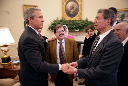 Meeting with citizens from Iraq, President George W. Bush talks with Maurice Shohet and Ali Alattar, center, in the Oval Office Tuesday, March 29, 2005. White House photo by Eric Draper