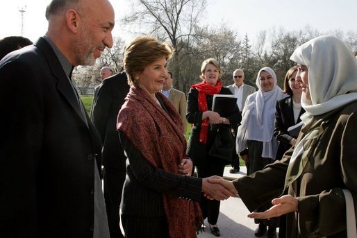 First lady Laura Bush and Margaret Spellings, Secretary of Education, center, stand with Afghan President Hamid Karzai Wednesday, March 30, 2005, after their arrival in Kabul. White House photo by Susan Sterner