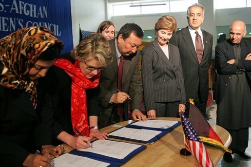 Laura Bush observes as Secretary of Education Margaret Spellings and Afghan Minister of Education Noor Mohammas Qarqeen complete the signing of the Memorandum of Understanding for funds to build a university in Kabul, Afghanistan Wednesday, March 30, 2005. White House photo by Susan Sterner