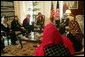 Laura Bush and Dr. Zenat Karzai, wife of President Hamid Karzai, center, join Paula Dobrianski, second from left, Under Secretary of State for Global Affairs, and Margaret Spellings, U.S. Secretary of Education, third from left, as they talk with Afghan women about issues of women's rights and education at the presidential residence in Kabul Wednesday, March 30, 2005. White House photo by Susan Sterner