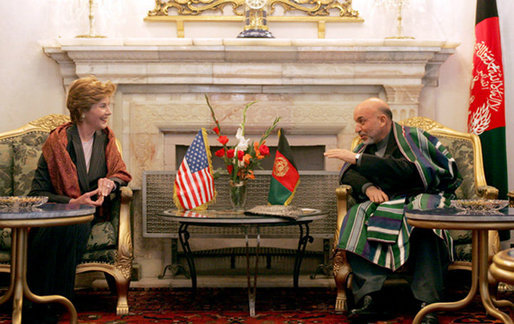 Afghan President Hamid Karzai jokes with Laura Bush during a meeting in the Presidential Palace in Kabul, Afghanistan Wednesday, March 30, 2005. White House photo by Susan Sterner