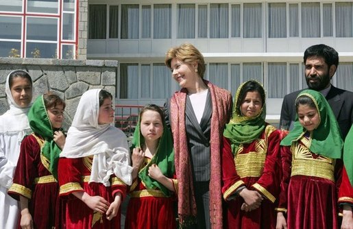 Mrs. Laura Bush stands with a group of Afghan girls on hand to greet her Tuesday, March 29, 2005, upon her arrival in Kabul. White House photo by Susan Sterner