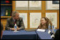 President Bush and 10-year-old Michaela Huberty exchange thoughts during a roundtable discussion Friday, April 1, 2005, at Paul Public Charter School in Washington DC. Michaela, a fourth-grader at Benjamin Mays Magnet School in St. Paul, Minn., is being raised by her mother while her father is in prison. As part of the President's Helping America's Youth initiative, Michaela joined the Kinship program in her hometown and gained a mentor, adding another positive adult in her life. White House photo by Eric Draper