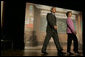The President and Mrs. Bush arrive on stage at Paul Public Charter School in Washington DC Friday, April 1, 2005. The first lady introduced the president who spoke to the audience about his Helping America's Youth initiative. White House photo by Krisanne Johnson