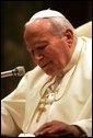 Pope John Paul II speaks after he was honored with the Medal of Freedom in June 2004, presented during his audience with President George W. Bush and Laura Bush. White House photo by Eric Draper