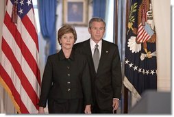 President George W. Bush and Mrs. Laura Bush walk into the Cross Hall prior to the President giving remarks on the death of Pope John Paul II at the White House on Saturday April 2, 2005.  White House photo by Paul Morse