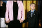 Eleven-year-old David Smith looks solemnly towards the audience as he and his step-sister Jessica, left, hold their mom's hands during ceremonies Monday, April 4, 2005, at the White House. David's father, Sgt. 1st Class Paul Smith, was honored posthumously by President Bush with the Medal of Honor, the first presented for service in support of Operation Iraqi Freedom.White House photo by Eric Draper