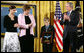 David Smith, 11-year-old son of Sgt. 1st Class Paul Smith, holds his father's Medal of Honor, awarded Monday, April 4, 2005, posthumously by President Bush during ceremonies at the White House. Looking on are Smith's wife, Birgit, and step-daughter Jessica.White House photo by Paul Morse