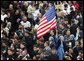 An American flag flies high above the throng of mourners inside St. Peter's square Friday, April 8, 2005, as thousands attend funeral mass for Pope John Paul II, who died April 2 at the age of 84.White House photo by Eric Draper