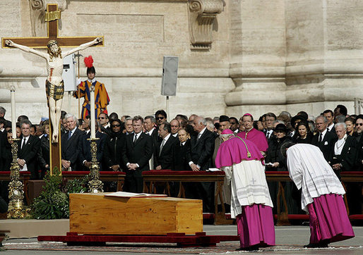 Archbishop Piero Marini, left, chief liturgist to Pope John Paul II, bows to his casket during the Pope's funeral Friday, April 8, 2005, in St. Peter's Square.White House photo by Eric Draper