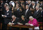 President George W. Bush and Laura Bush stand amidst mourners at funeral services Friday, April 8, 2005, for the late Pope John Paul II in St. Peter's Square. The funeral is being called the largest of its kind in modern history.White House photo by Eric Draper