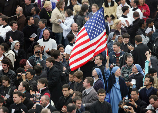 An American flag flies high above the throng of mourners inside St. Peter's square Friday, April 8, 2005, as thousands attend funeral mass for Pope John Paul II, who died April 2 at the age of 84. White House photo by Eric Draper