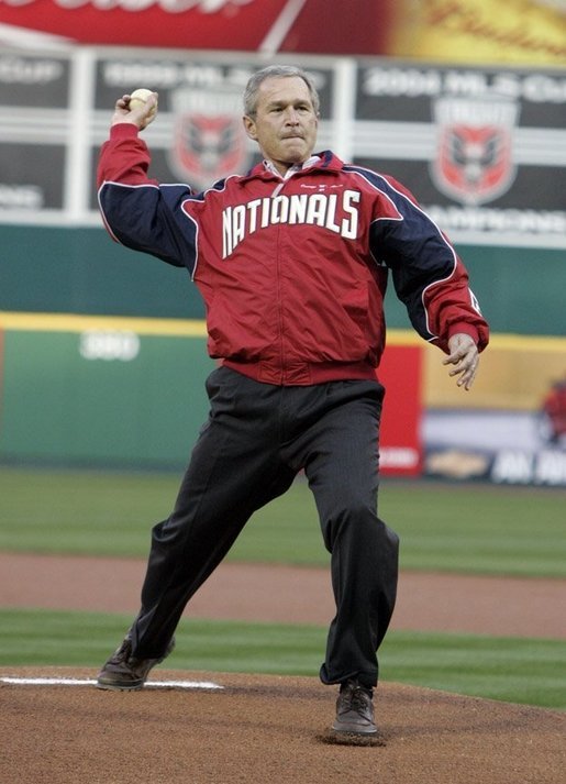 President George W. Bush throws out the opening pitch of the Washington DC Nationals home opener at RFK Stadium in Washington DC on Thursday April 14 2005. White House photo by Paul Morse