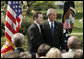 President George W. Bush and Jason Kamras, 2005 National Teacher of the Year, stand for photos in the Rose Garden Wednesday, April 20, 2005, after Mr. Kamras, a 7th and 8th grade math teacher at John Philip Sousa Middle School in Washington, D.C., was honored for his work. White House photo by Krisanne Johnson