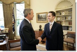President George W. Bush welcomes Jason Kamras, the 2005 National Teacher of the Year, to the Oval Office during ceremonies Wednesday, April 20, 2005, at the White House. Mr. Kamras, a 1996 Princeton graduate, teaches seventh and eighth grade math at John Philip Sousa Middle School in Washington, D.C. "Teaching is a commitment to equity and opportunity for all children," says Mr. Kamras, who took time away from teaching in 1999-2000 to earn his Master's degree at Harvard. "It is a promise of a better future for those who have been left behind."  White House photo by Eric Draper