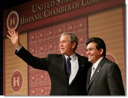 President George W. Bush stands with Attorney General Alberto Gonzales as they acknowledge the applause after the President addressed the Hispanic Chamber of Commerce Legislative Conference Wednesday, April 20, 2005, in Washington, D.C.  White House photo by Eric Draper