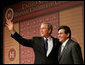 President George W. Bush stands with Attorney General Alberto Gonzales as they acknowledge the applause after the President addressed the Hispanic Chamber of Commerce Legislative Conference Wednesday, April 20, 2005, in Washington, D.C. White House photo by Eric Draper
