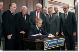  President George W. Bush signs into law S.256, the Bankruptcy Abuse Prevention and Consumer Protection Act of 2005, Wednesday, April 20, 2005, at the Eisenhower Executive Office Building. Watching on, from left are: Senator Tom Carper, D-Del.; Congressman Steve Chabot, R-Ohio; House Speaker Dennis Hastert, R-Ill.; Congressman Jim Sensenbrenner, Jr., R-Wis., Chairman of the Judiciary Committee; Senator Chuck Grassley, R-Iowa, chairman of the Finance Committee; Senator Mitch McConnell, R-Ky.; Majority Whip Senator Orrin Hatch, R-Utah, and Congressman Rick Boucher, D-Va.  White House photo by Paul Morse
