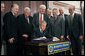  President George W. Bush signs into law S.256, the Bankruptcy Abuse Prevention and Consumer Protection Act of 2005, Wednesday, April 20, 2005, at the Eisenhower Executive Office Building. Watching on, from left are: Senator Tom Carper, D-Del.; Congressman Steve Chabot, R-Ohio; House Speaker Dennis Hastert, R-Ill.; Congressman Jim Sensenbrenner, Jr., R-Wis., Chairman of the Judiciary Committee; Senator Chuck Grassley, R-Iowa, chairman of the Finance Committee; Senator Mitch McConnell, R-Ky.; Majority Whip Senator Orrin Hatch, R-Utah, and Congressman Rick Boucher, D-Va. White House photo by Paul Morse