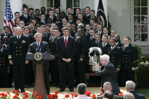 President George W. Bush and the Midshipmen of the U.S. Naval Academy's football team, break out in laughter as Sen. John McCain, R-Ariz., acknowledges his late arrival Wednesday, April 20, 2005, to the Rose Garden presentation of the Commander-in-Chief Trophy. The trophy is awarded after each season to the service academy with the best overall record against the other two. White House photo by Paul Morse
