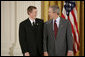 President George W. Bush congratulates Scott Elder, 15, of Chino Hills High School in Chino Hills, Calif., on receiving the President’s Environmental Youth Award in the East Room of the White House April 21, 2005. White House photo by Paul Morse