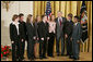 President George W. Bush congratulates members of the Cairo High School Science Club and Biology Students’ Environmental Issues Outreach Program in Cairo, Ga., on receiving the President’s Environmental Youth Award in the East Room of the White House April 21, 2005. Members of this club include, from left, Anna Dorsey, 16, Luke Walden, 16, Brian Dekle, 19, Jessica Brock, 19, John Palmer, 16, Keri Cassels, 16, Brandon Phillips, 19, and Vikram Jambulapati, 18. White House photo by Paul Morse