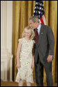 President George W. Bush congratulates Allyson Lien, 11, of Humann Elementary School in Lincoln, Neb., on receiving the President’s Environmental Youth Award in the East Room of the White House April 21, 2005. White House photo by Paul Morse